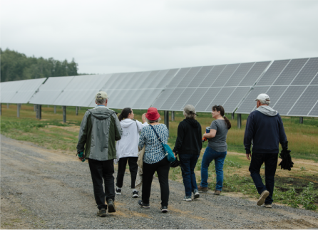 group of Nautilus employees walking and looking at a solar farm